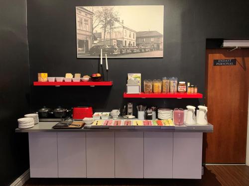 a counter with plates and other items on it at Arboga Stadshotell in Arboga