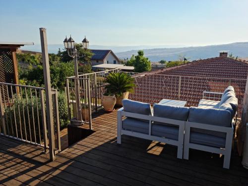 a patio with a bench on a roof at mimar מימאר אירוח כפרי מפנק in Had Nes