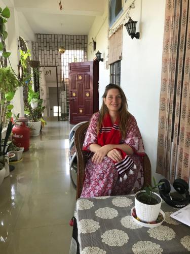 a woman sitting in a chair in a room at Blissful Eyrie in Guwahati