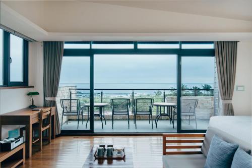 a bedroom with a view of a living room at Adagio Shihtiping in Fengbin