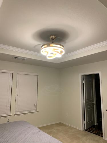 a bedroom with a bed and a ceiling with a light at N-E-G House - near DAVID WAYNE HOOKS Airport in Houston