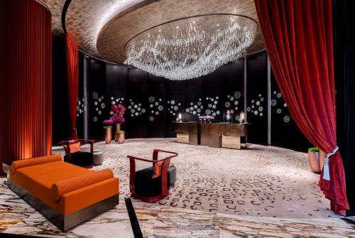 a living room with a couch and a chandelier at Jumeirah Guangzhou - Complimentary Shuttle Bus to Canton Fair Complex in Guangzhou