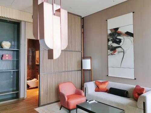 a living room with a couch and a chair at Jumeirah Guangzhou - Complimentary Shuttle Bus to Canton Fair Complex in Guangzhou