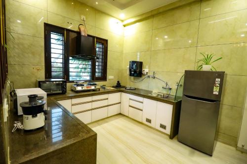 a kitchen with a refrigerator and a counter top at Lavanya Villa with private pool Udaipur in Udaipur