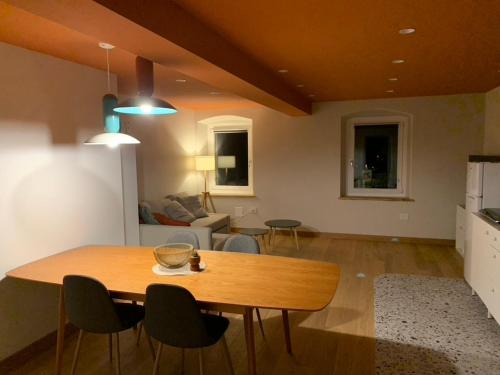 a kitchen and living room with a table and chairs at Albergo Stella in Cavalese