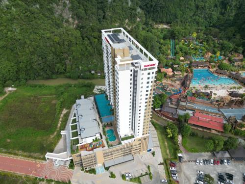 an overhead view of a large white building with a pool at Cozy Suite with 270 Degree Mountain and Theme Park Views in Ipoh