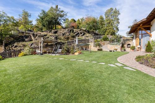 a yard with a playground with a hill in the background at Florerhof Ferienwohnung Lavendel in Vols am Schlern