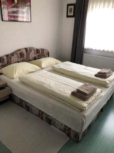 two twin beds in a room with a window at Hava apartment in Sarajevo