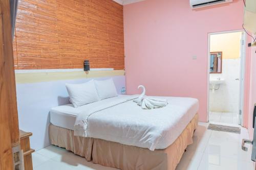 a bedroom with a large bed in a room at Metro Malioboro Living in Yogyakarta