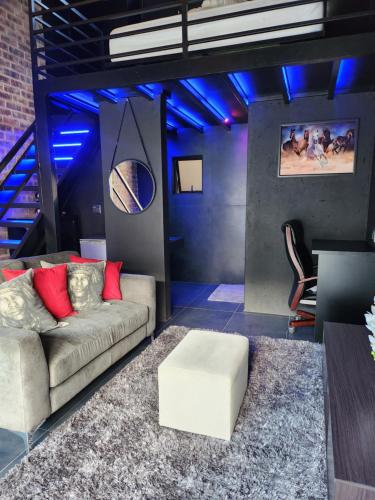 a living room with a couch and blue lights at 17 On Buffalo in Johannesburg
