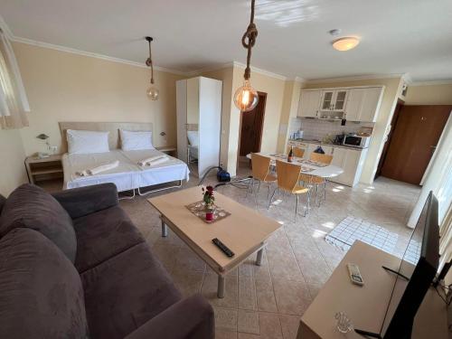 a living room with a couch and a bed and a table at Cosy Apartment with Sea view in Santa Marina in Sozopol