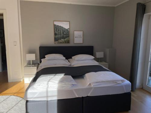 a bedroom with a large bed with white sheets and pillows at S´Kraftplatzl in Bad Aussee