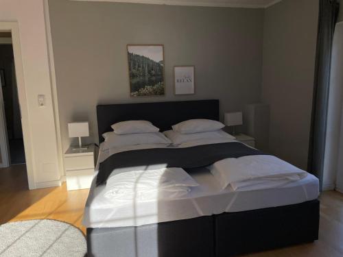 a bedroom with a large bed with white sheets and pillows at S´Kraftplatzl in Bad Aussee