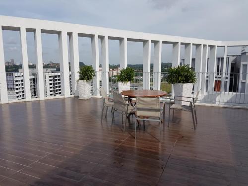 a balcony with a table and chairs on a building at SJB Suria Jelutong in Shah Alam