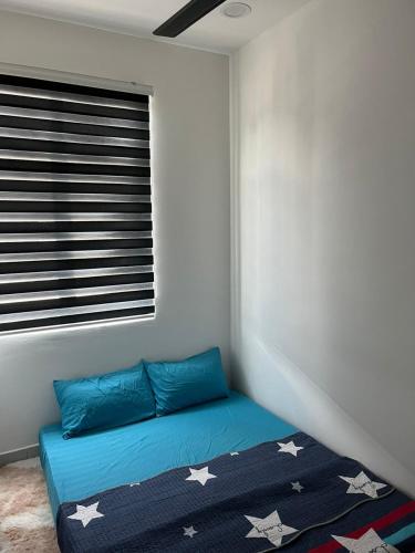 a bedroom with a blue bed with stars on it at Sure Stay Homestay in Simpang Ampat