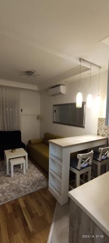 a kitchen and living room with a couch and a table at Cozy place in Trebinje