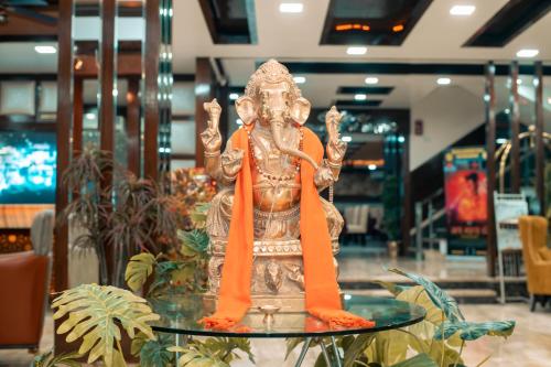 a statue sitting on a glass table in a store at The Fern Residency Katra in Katra