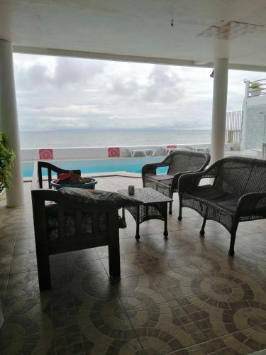 a patio with chairs and a view of the ocean at Germaroze in Oslob