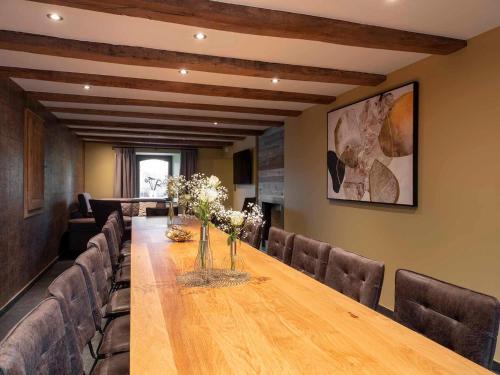 a conference room with a long wooden table and chairs at La Maison du Notaire - Gîte 18 personnes in Houffalize