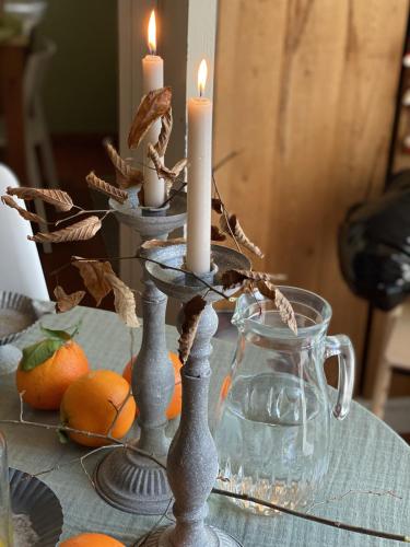 a table with candles on top of a table with oranges at B&B MELLONI STREET in Dolo