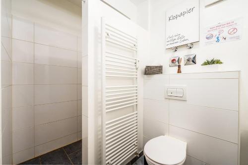 a white bathroom with a toilet in a room at Work & Stay Apartment in Gelsenkirchen in Gelsenkirchen
