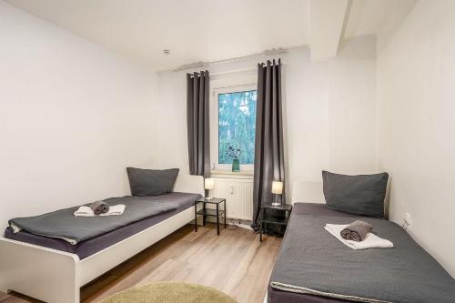 a bedroom with two beds and a window at Work & Stay Apartment in Gelsenkirchen in Gelsenkirchen