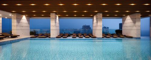 a large swimming pool with chairs in a building at Virgo Hotel Nha Trang in Nha Trang