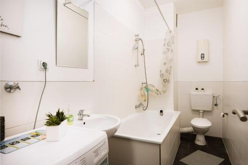 a white bathroom with a sink and a toilet at work & stay in Gelsenkirchen in Gelsenkirchen