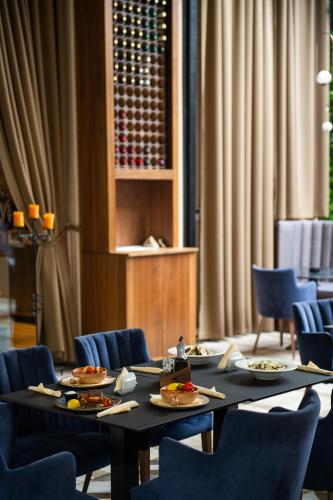 a dining room with a table with plates of food at CRYSTAL Hotel Belgrade in Belgrade