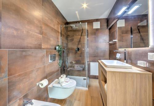 a bathroom with a toilet and a sink and a shower at Boutique Homes in Lugano