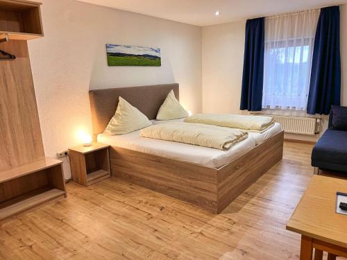 a bedroom with a bed and a couch in a room at Hotel Gasthof Altmann in Warzenried