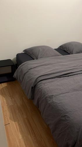 uma cama num quarto com piso em madeira em Appartement type T3 vaulx la soie em Vaulx-en-Velin