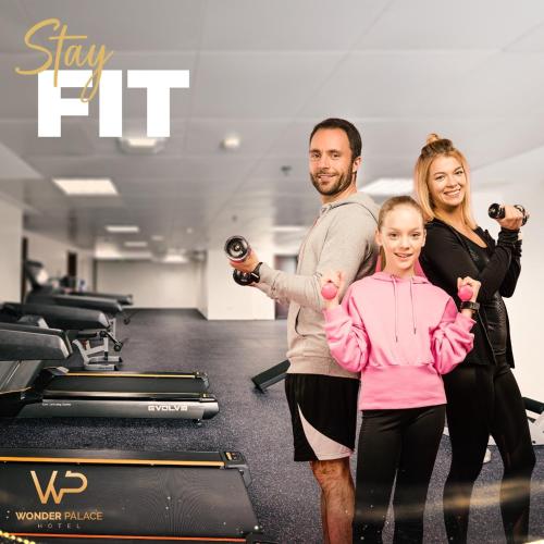 a man and a woman standing in a gym with weights at Wonder Palace Hotel Qatar in Doha