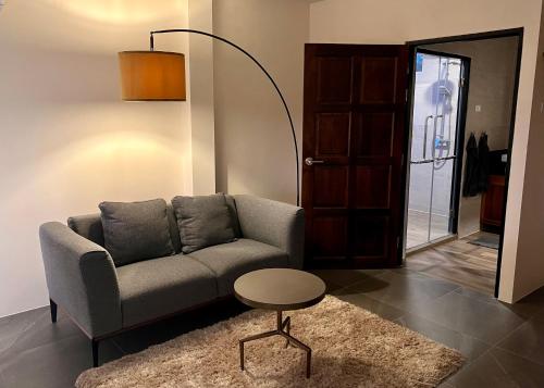 a living room with a couch and a table at I love phants Lodge in Ban Huai Thawai