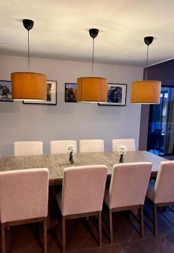 a dining room with a wooden table and chairs at I love phants Lodge in Ban Huai Thawai