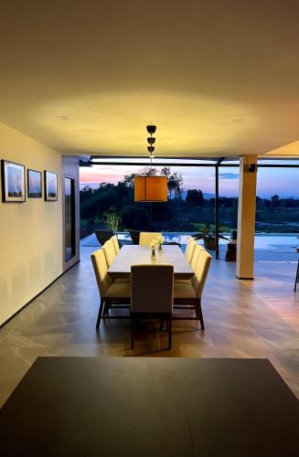 a dining room with a table and yellow chairs at I love phants Lodge in Ban Huai Thawai