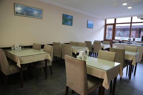 a dining room with tables and chairs in a restaurant at Otel 57 in Sinop