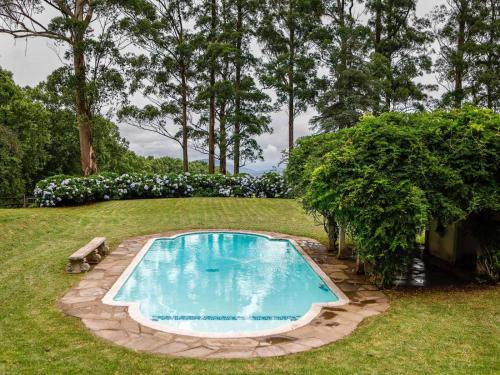 a swimming pool in the middle of a yard at Backworth House in Mid Illovo