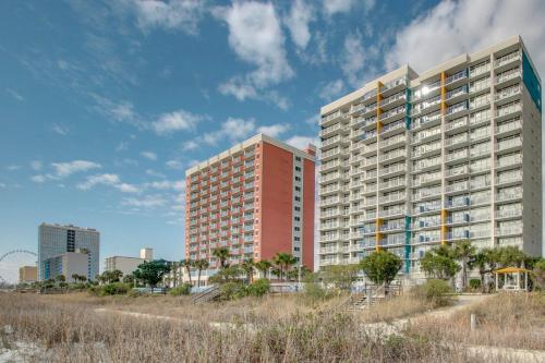 two tall buildings on the beach in front of a city at 1BR Beach Condo in Atlantica Resort near Boardwalk in Myrtle Beach