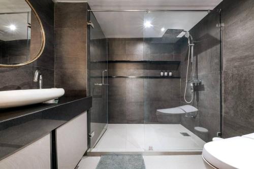a bathroom with a shower and a sink and a toilet at Central Bangkok Loft Style Skyline 100 sq.m. Apt in Bangkok