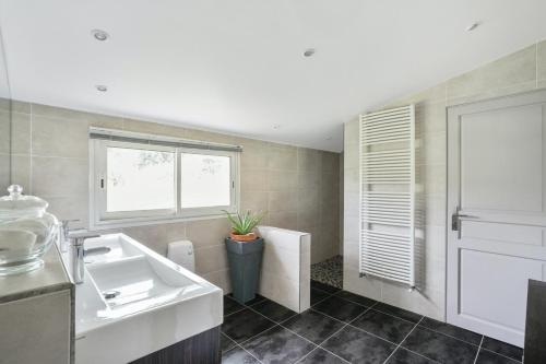 a bathroom with a sink and a toilet and a window at Villa de 4 chambres avec piscine privee jardin amenage et wifi a Saint Sylvestre sur Lot in Saint-Sylvestre-sur-Lot