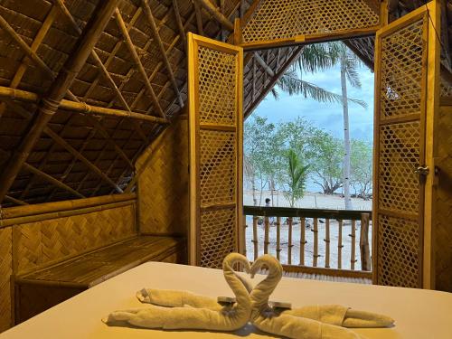 a room with two towels on a table with a window at Kanipa Beach Glamping in El Nido