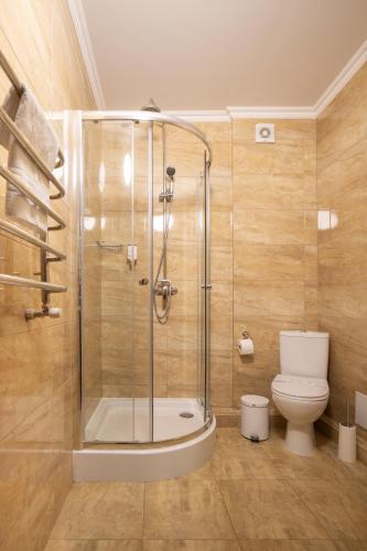 a bathroom with a shower and a toilet at Private Rooms in Hotel 3 поверх in Bukovel