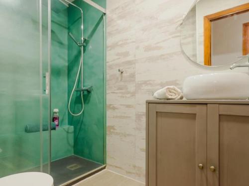 a bathroom with a glass shower and a sink at Aparta-club la Barrosa 116 in Chiclana de la Frontera