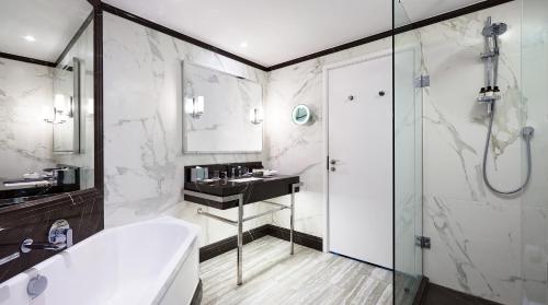 a bathroom with a tub and a shower and a sink at Fairmont St Andrews, Scotland in St. Andrews