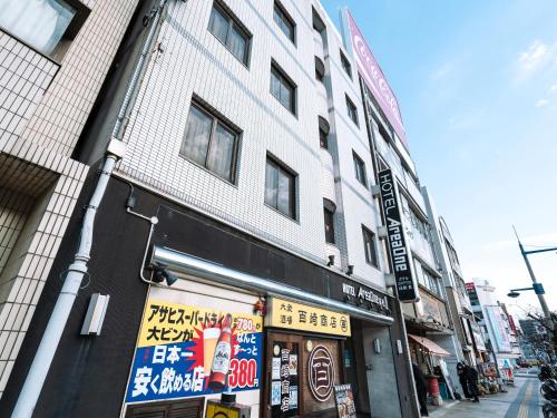 a building on a street in an asian city at Hotel AreaOne Takamatsu in Takamatsu