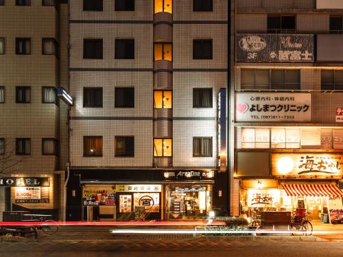 a building at night with lights in front of it at Hotel AreaOne Takamatsu in Takamatsu