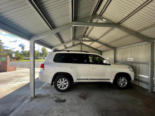 a white suv parked in a garage at Downtown Narrabri Apartment in Narrabri