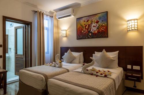 Postel nebo postele na pokoji v ubytování PrideInn Hotel Diani