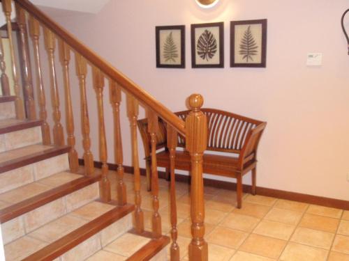 a stairway with a wooden stair case with a bench at Hotel Ekai in Ecay